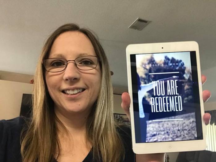 Me holding You Are Redeemed ebook
